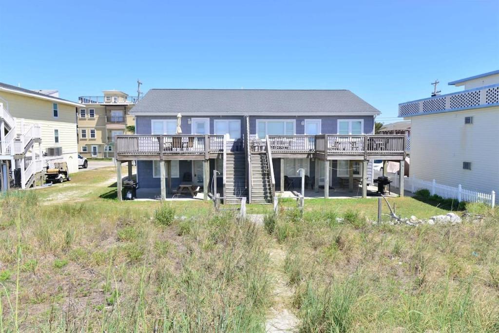 a large house with a deck on the beach at HAZELS CHILD II Beach House DIRECT OCEANFRONT Ocean and Pier Views in Myrtle Beach