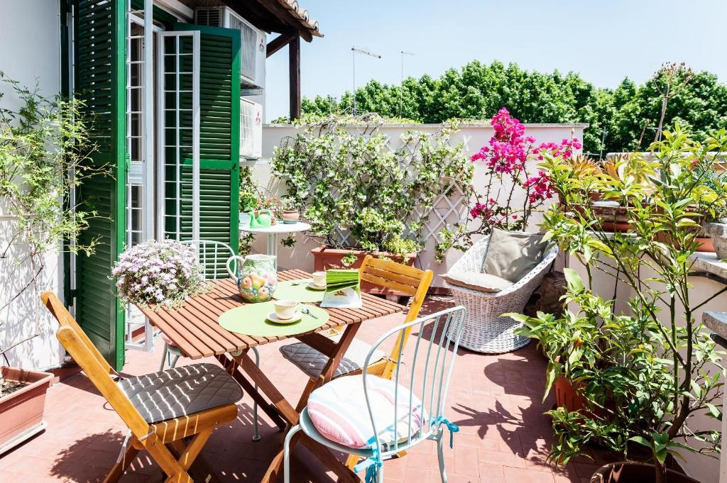 a patio with a table and chairs and plants at Otranto in Rome