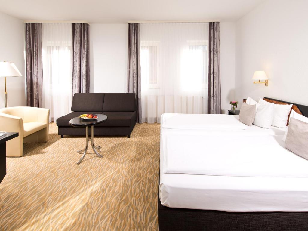 Postel nebo postele na pokoji v ubytování ACHAT Hotel Bochum Dortmund