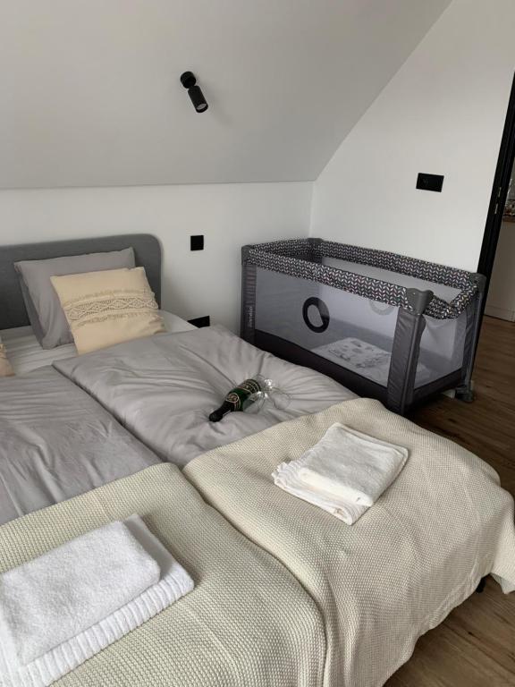 a bedroom with a bed with two towels on it at Apartamenty Astor - Słoneczny in Szczawno-Zdrój