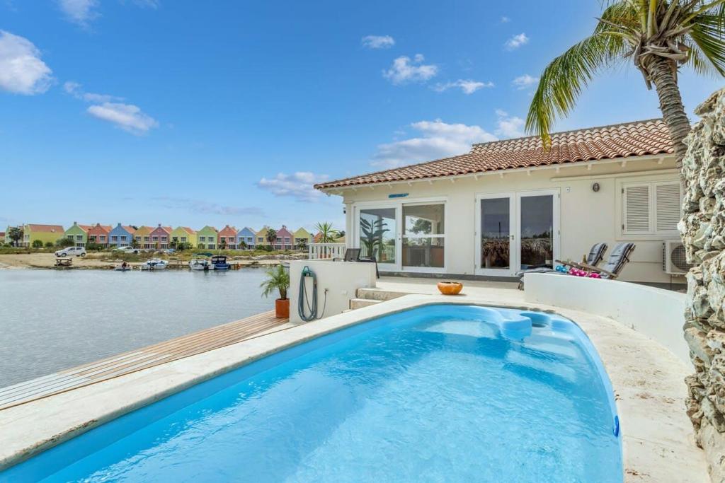 a swimming pool in front of a house at Kas Jacco in Laguna Marina in Kralendijk