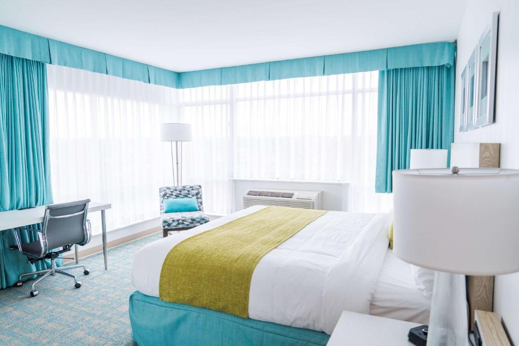 a hotel room with a bed and a desk at Coast Hotel & Convention Centre in Langley