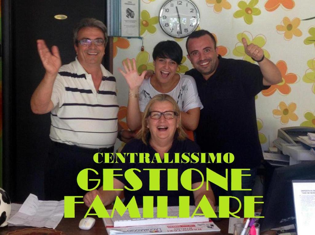 a group of people posing for a picture in an office at Hotel Ausonia in Rimini