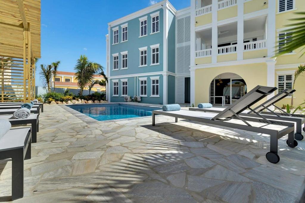 a villa with a swimming pool and a house at Kas Ereda Ground floor Apartment with Pool in Kralendijk