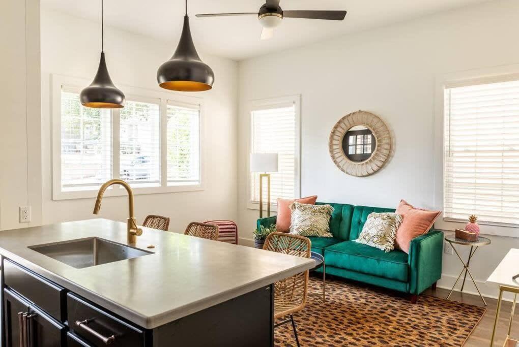 a kitchen and living room with a green couch at Bohemian Bliss in Atlanta