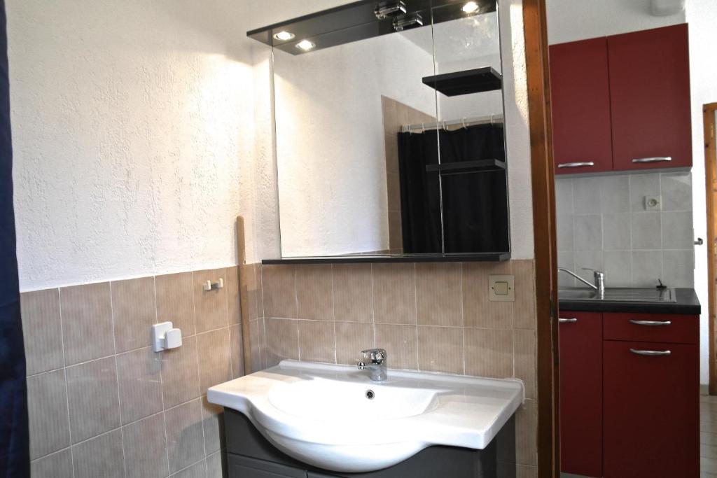 a bathroom with a white sink and a mirror at Residence Thalassa in Calvi