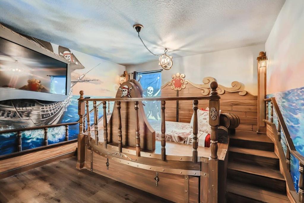 a childs bedroom with a pirate ship mural at Amazing 8br w pool theater game room by Disney in Kissimmee