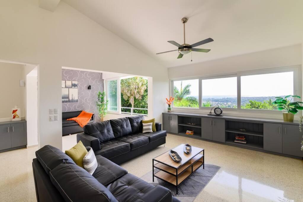 a living room with a couch and a table at Casa Mango- Mountain & Sea Panoramic view - 3Bedrooms in San Felipe de Puerto Plata