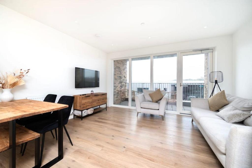 a living room with a couch and a table at Chic 2BR Flat in Greater London in London