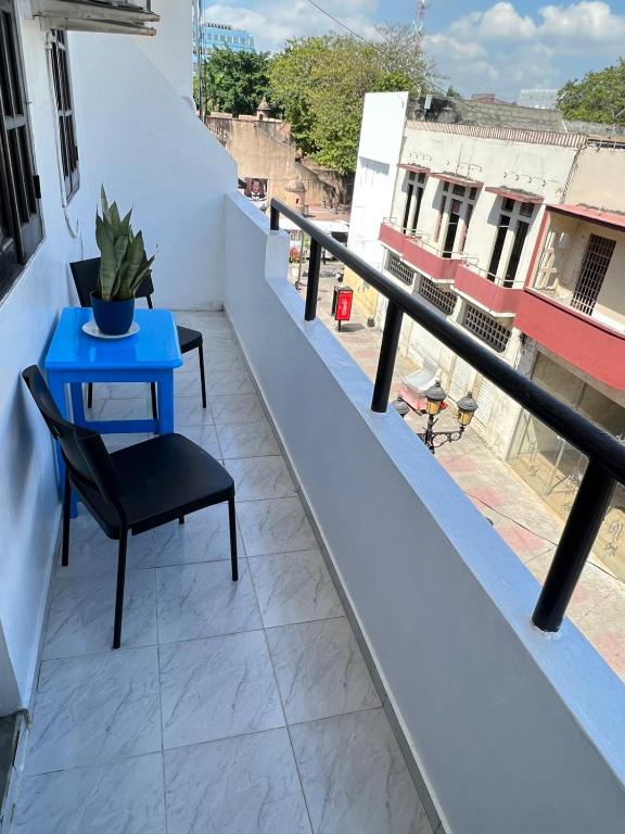 a blue table and a chair on a balcony at YOUR SPACE COLONIAL in Santo Domingo