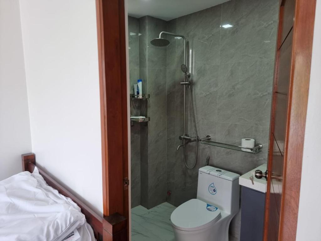 a bathroom with a shower and a toilet in a room at Mary Ann Gurel, Amaya 2 Tanza Cavite Staycation, Transient, Short Term,Long Term, Condo Type with own Balcony. in Tanza