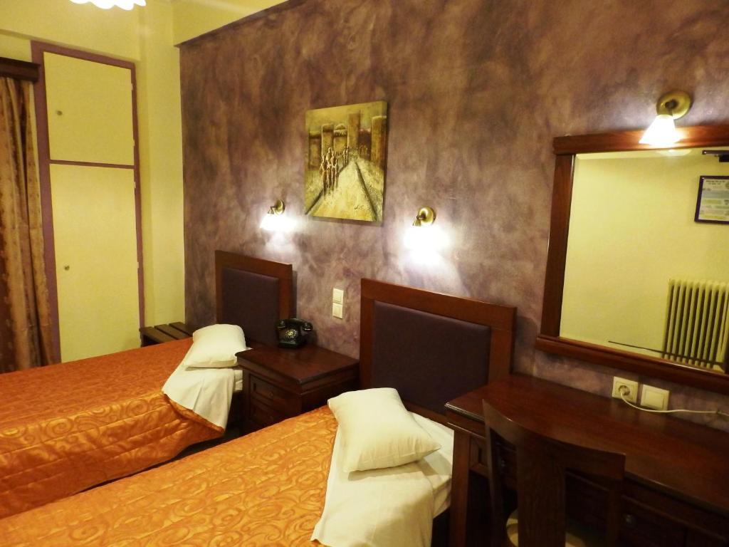 Postel nebo postele na pokoji v ubytování Pergamos Hotel