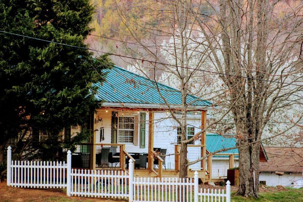 a small house with a white fence in front of it at The Bailey Hot Springs in Hot Springs