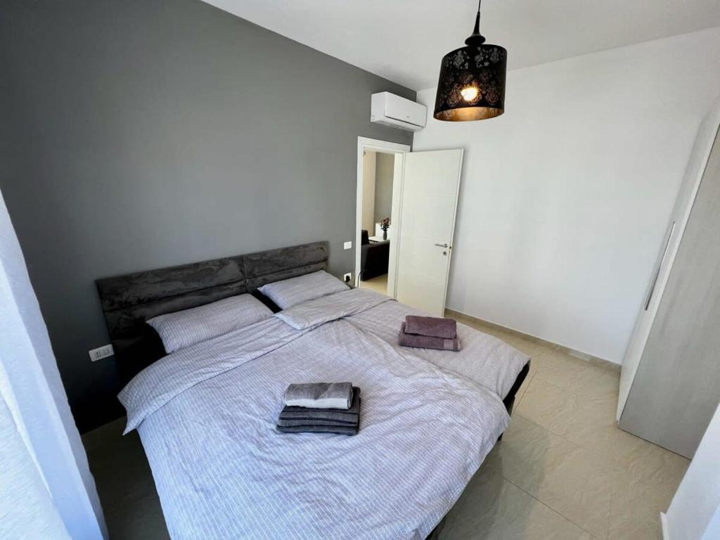 a bedroom with a large bed with two towels on it at Villa Golem 595 in Golem