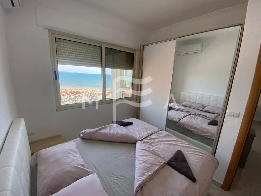 a bedroom with a bed and a large mirror at SEAVIEW apartment 616 in Durrës