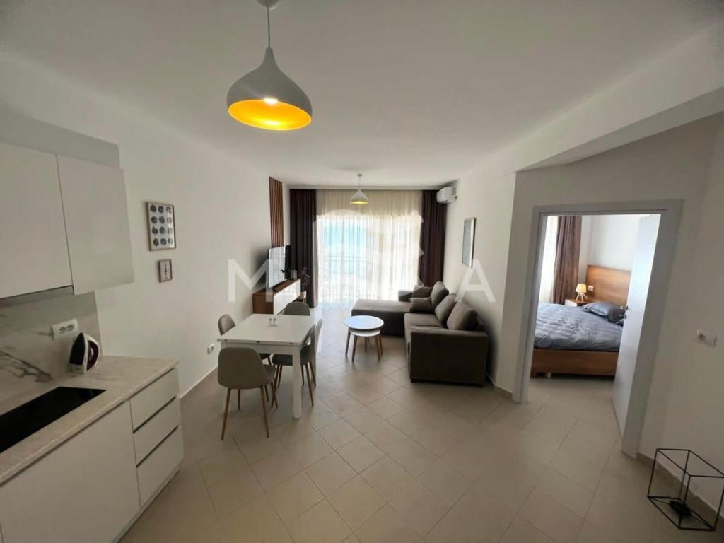 a kitchen and living room with a couch and a table at Interstellar 830 in Durrës