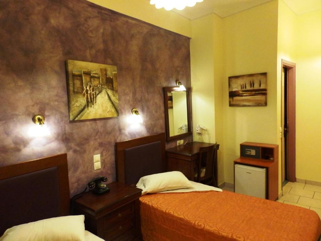 Postel nebo postele na pokoji v ubytování Pergamos Hotel