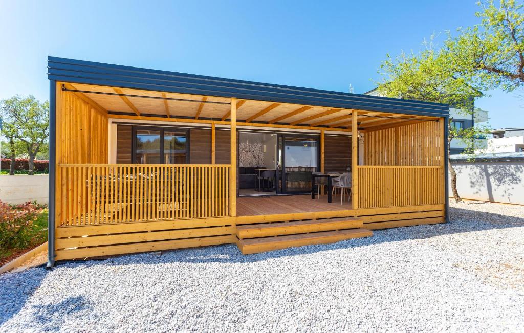 a small house with a large deck at 2 Bedroom Amazing Home In Banjole in Banjole