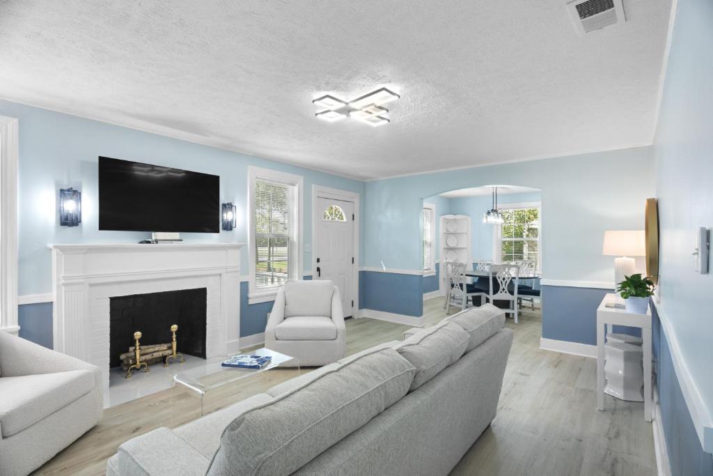 a blue living room with a couch and a tv at Forest Hills Manor in Augusta