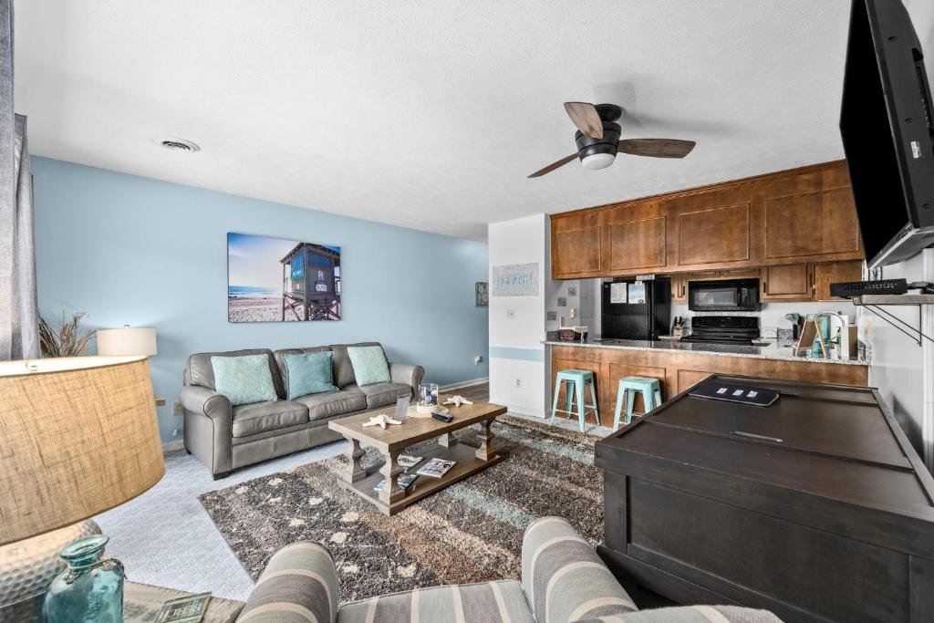a living room with a couch and a tv at Salty Air Retreat in Myrtle Beach