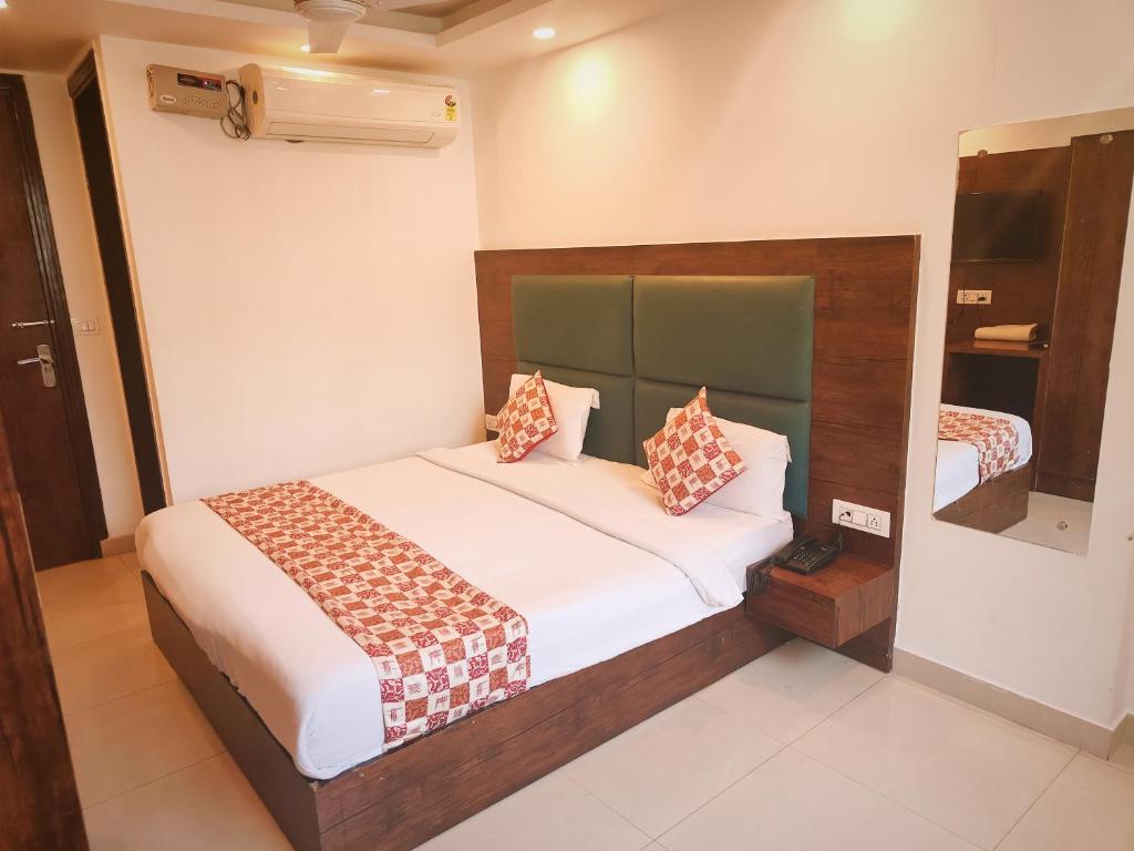 a bedroom with a large bed in a room at Hotel D Tark Near IGI Airport in New Delhi