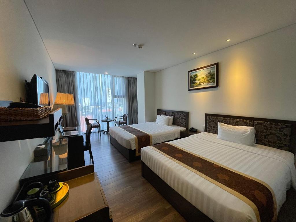 Postel nebo postele na pokoji v ubytování Danaciti Hotel