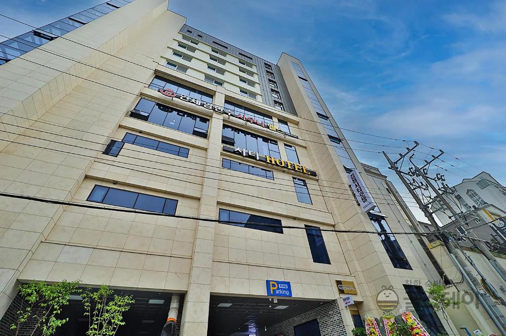 a building with a sign on the front of it at Gimhae City Hotel in Gimhae