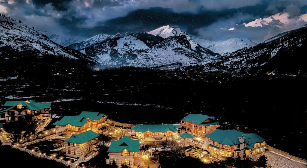 an aerial view of a resort in the mountains at night at Storii By ITC Hotels Urvashis Retreat, Manali in Manāli