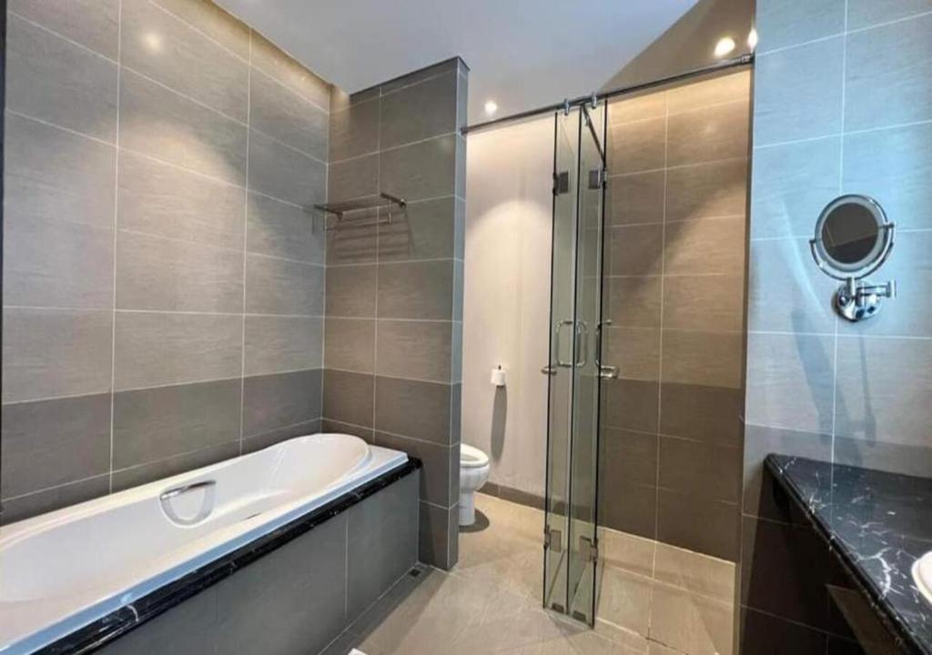 a bathroom with a tub and a shower and a toilet at Apartment with Ocean view in Danang