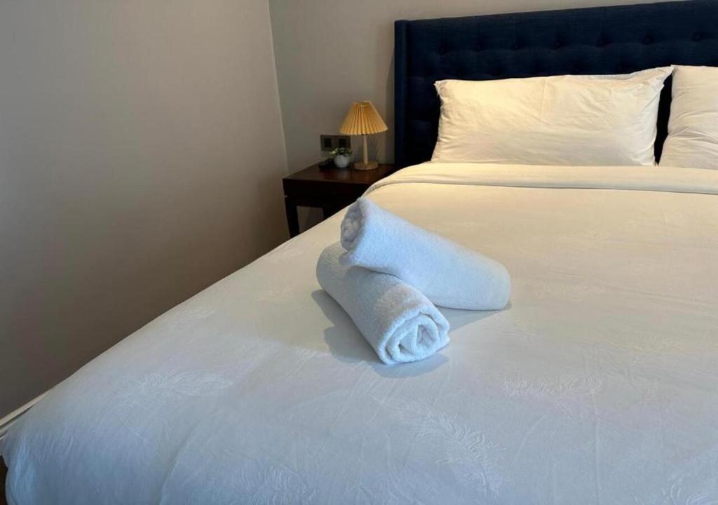 a hotel room with a bed with a towel on it at Apartment with Ocean view in Danang