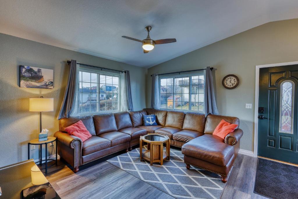 a living room with a brown leather couch and windows at Serene Retreat Charming 2 Bedroom Apt Sleeps 4 in Kodiak