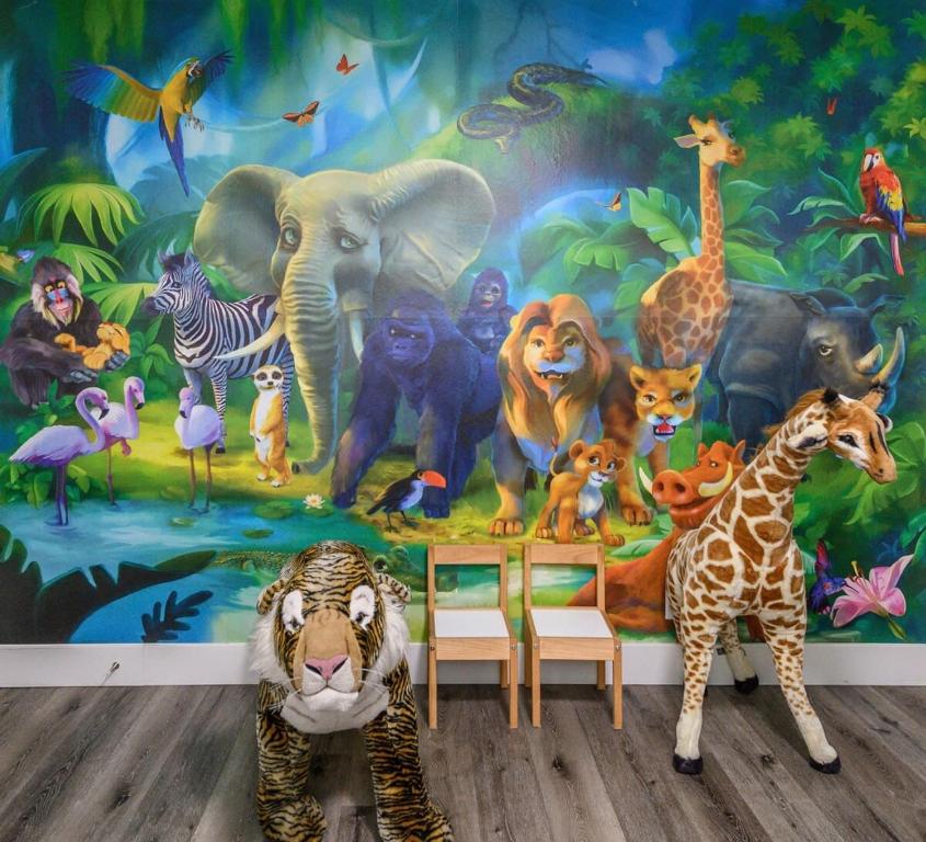 a room with a mural of animals on the wall at Safari Escape Disneyland 5 Bedroom 4 Bath Game Rm in Anaheim