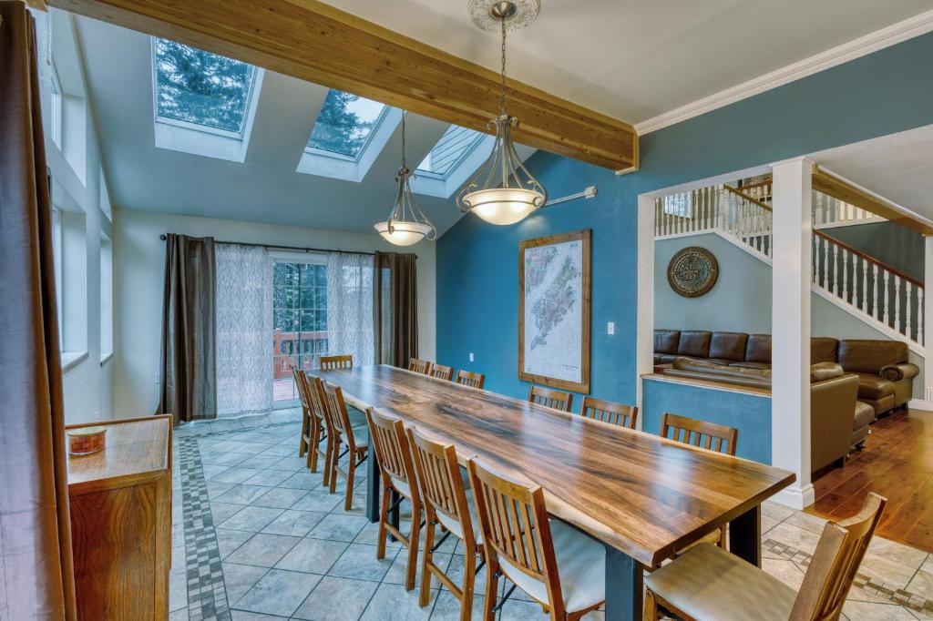 a dining room with a long table and chairs at Lodge Style Living Spacious 5BR Reunion Getaway in Kodiak