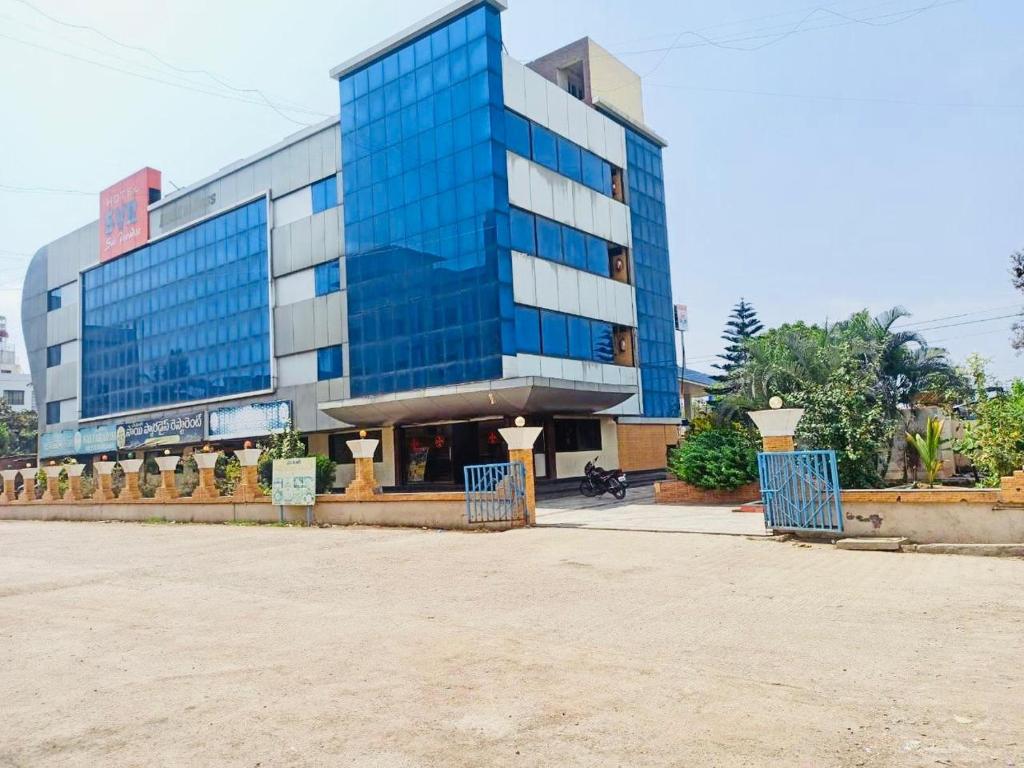a building with blue windows in front of it at SVR Sai Paradise Hotel in Shirdi