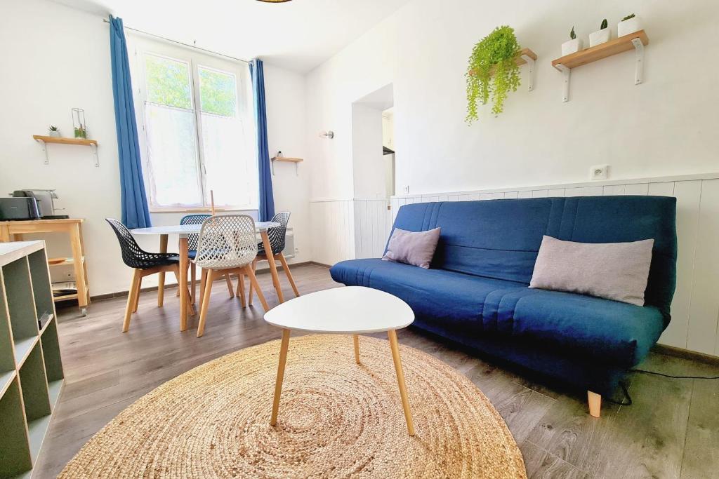 a living room with a blue couch and a table at Cosy apartment in the heart of Marseille - Welkeys in Marseille