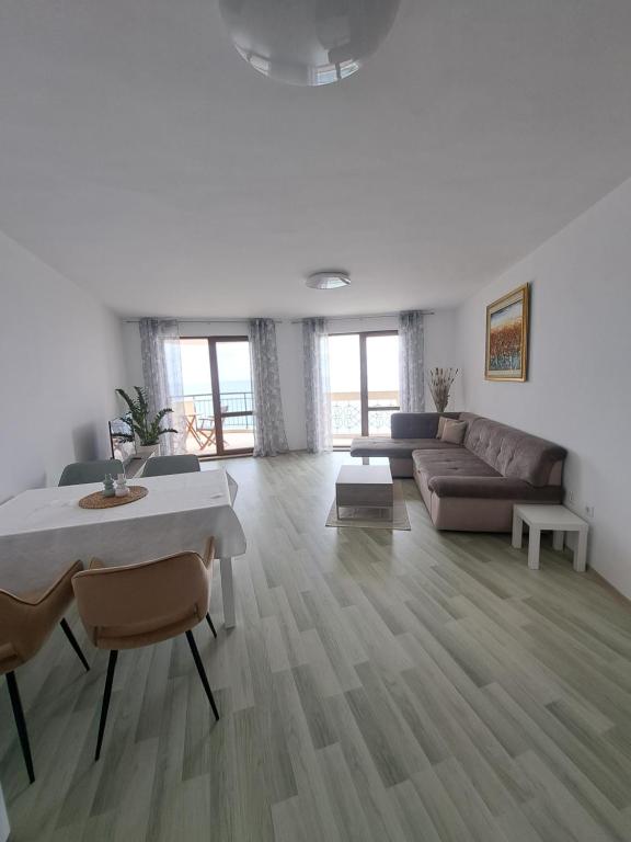 a living room with a couch and a table at Apartment Aphaya, complex Carpe Diem, Апартамент Афайя, комплекс Карпе Дием in Balchik