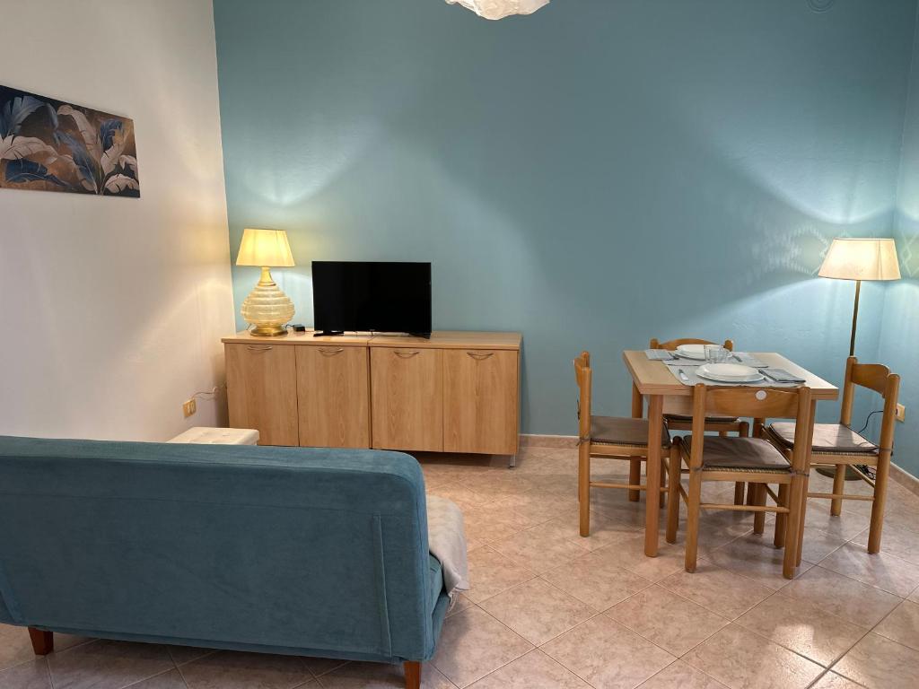 a living room with a couch and a table at Villa Bucchi in Lido di Spina