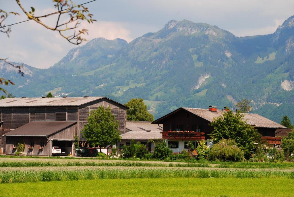 ein Bauernhof mit Bergen im Hintergrund in der Unterkunft Ferienhof Kopf in Mäder