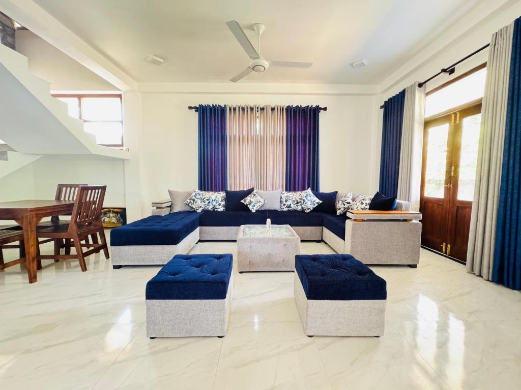 a living room with a couch and a table at Hikka Garden Villa in Hikkaduwa