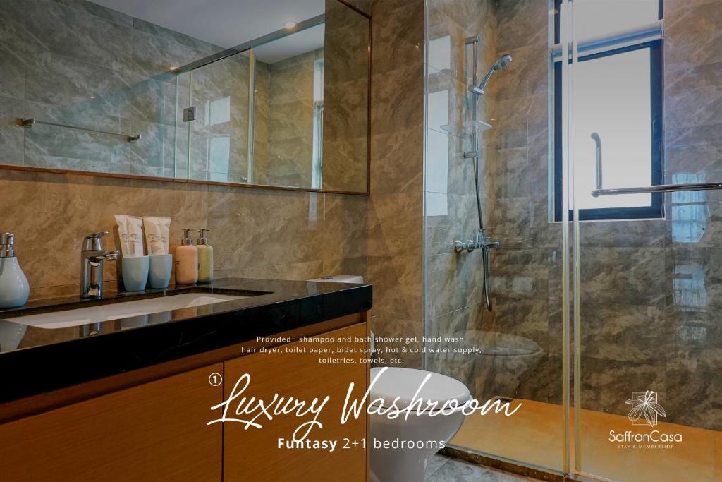 La salle de bains est pourvue d'une douche en verre et d'un lavabo. dans l'établissement R&F Princess Cove JB By SaffronCasa JB, à Johor Bahru