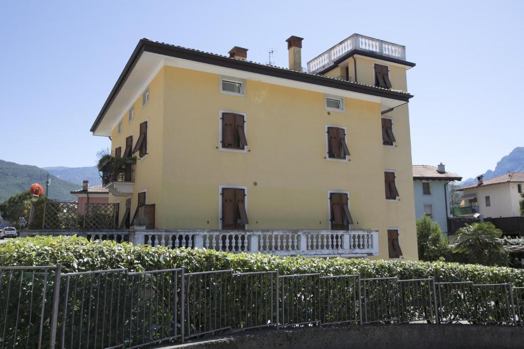 a yellow house with a fence in front of it at Casa Franco e Ilva - Happy Rentals in Arco