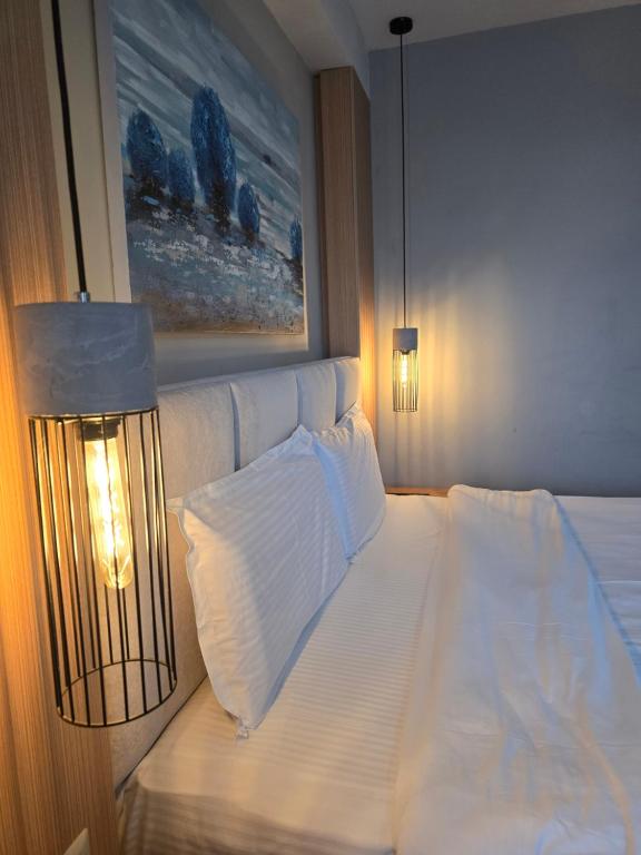 Postel nebo postele na pokoji v ubytování Perla Hotel