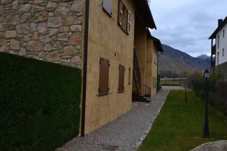 a stone building with windows on the side of it at Duplex el Pla de la Tour in Latour-de-Carol