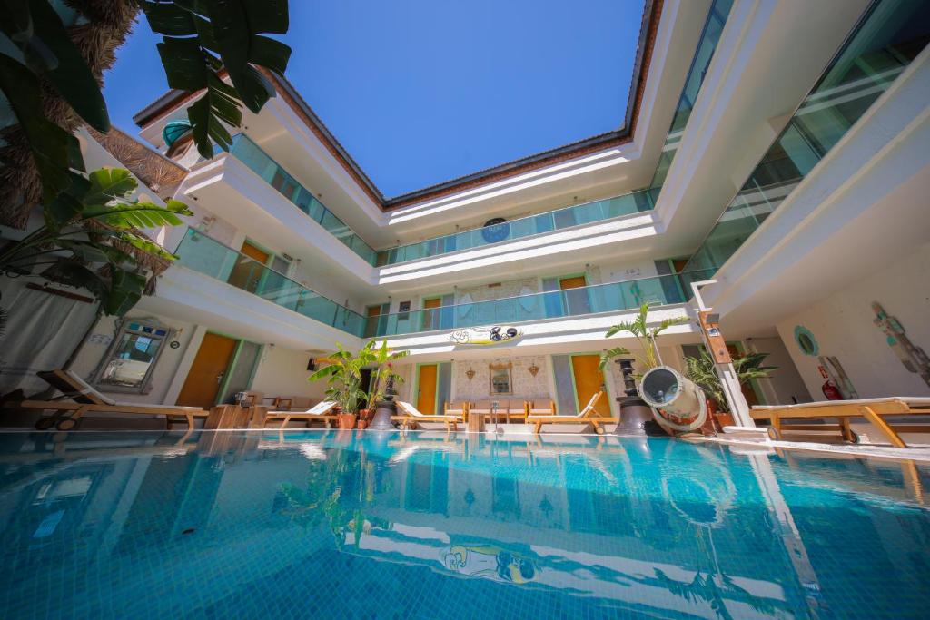 a large swimming pool with tables and chairs in a building at Brera Alacati - Special Category in Alaçatı