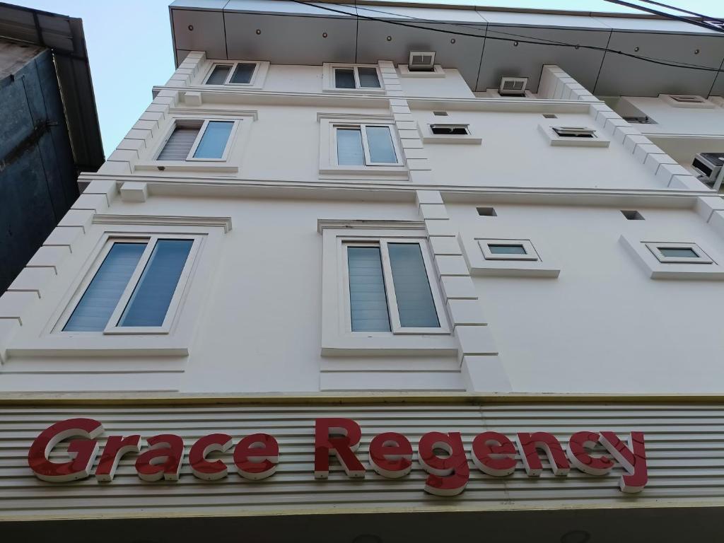 a white building with a greed agency sign in front of it at GRACE REGENCY in Ernakulam