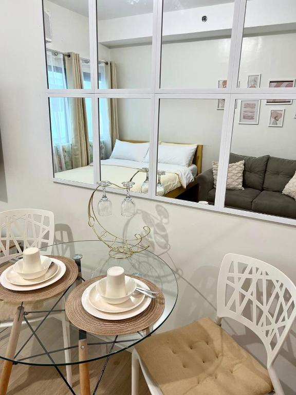 a living room with two tables and a mirror at Casa Luna Unit 1 in Manila
