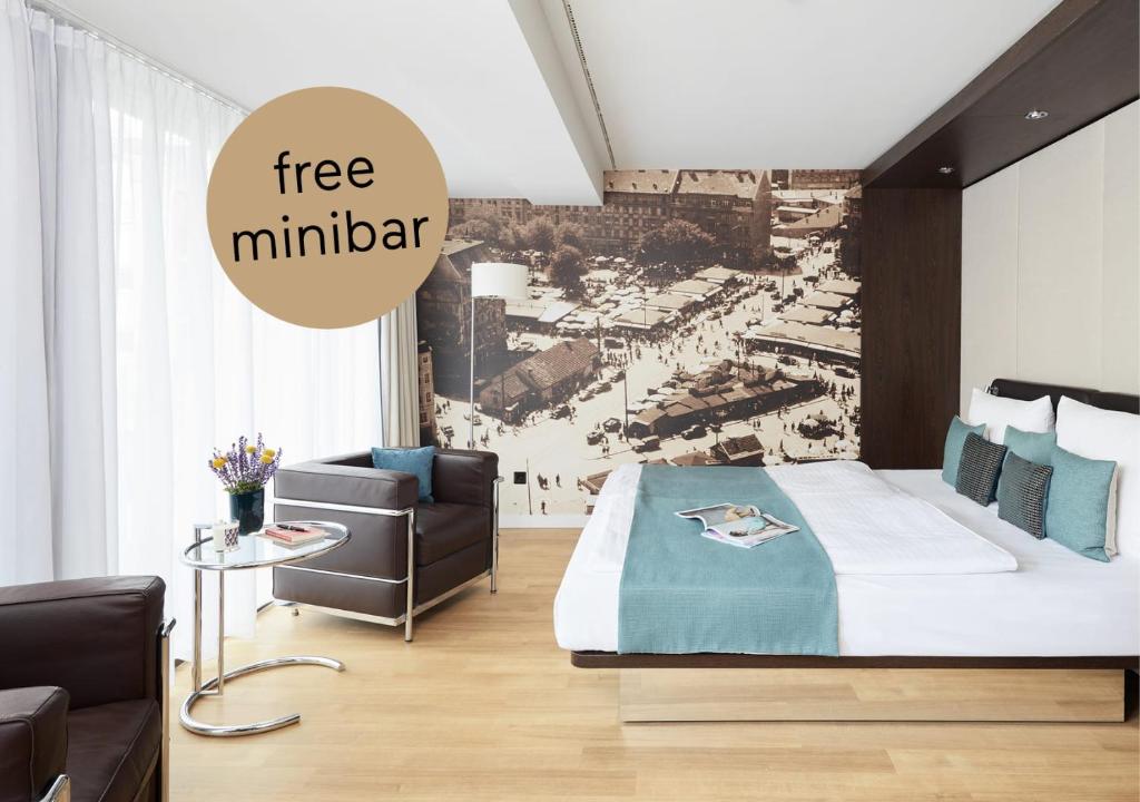 a bedroom with a bed and a couch and a chair at Living Hotel Das Viktualienmarkt in Munich