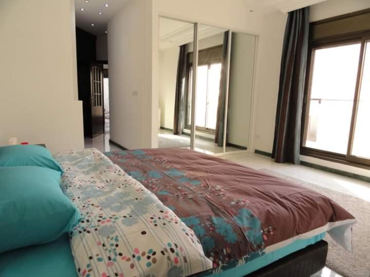 a bedroom with a bed and a large mirror at Jordan home in Irbid