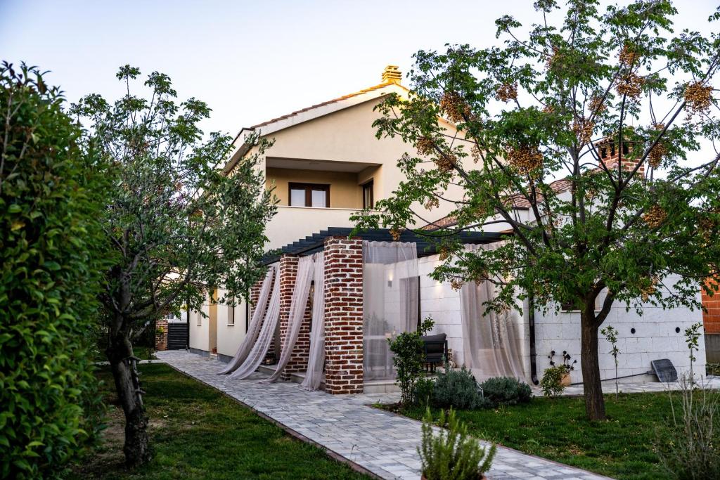 a house with a fence in front of it at House "Mediterrian spirit" with jacuzzi in Zadar in Zadar