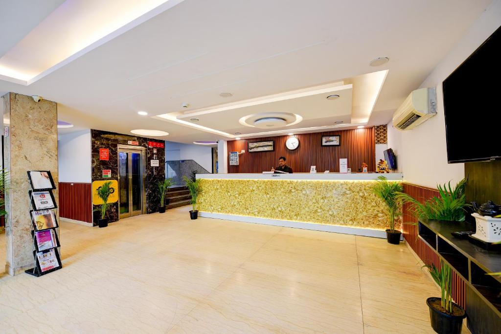 a lobby of a hotel with a reception counter at Belwood Inn Hotel Near Delhi Airport in New Delhi